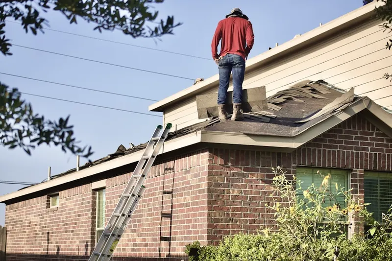 Professional roofer working on a residential roof in Oak Valley